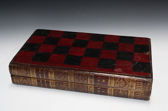 Appraisal: A LEATHER BOUND FOLDING CHESS AND BACKGAMMON BOARD in book