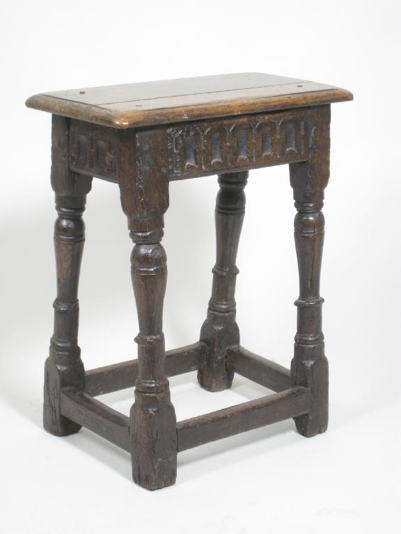 Appraisal: An antique oak Joined Stool with carved frieze on baluster