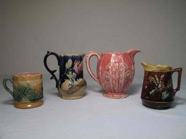 Appraisal: Lot of four Majolica pottery pitchers Includes an English Majolica