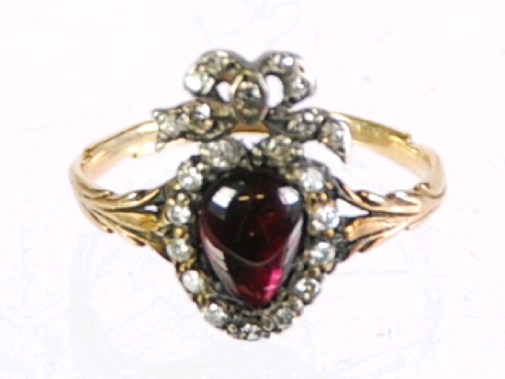 Appraisal: GOLD RING SET WITH A HEART SHAPED CABOCHON GARNET with