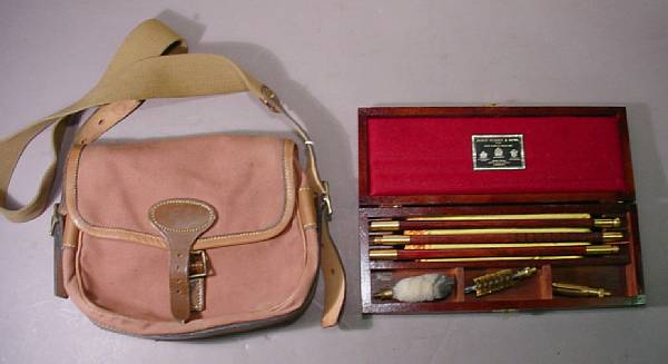 Appraisal: A cased cleaning kit and hunting bag by James Purdey