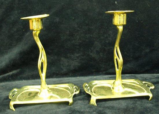 Appraisal: A pair of Art Nouveau brass candlesticks cm high