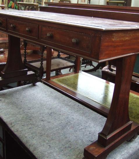 Appraisal: A th century mahogany side table with ledge back over