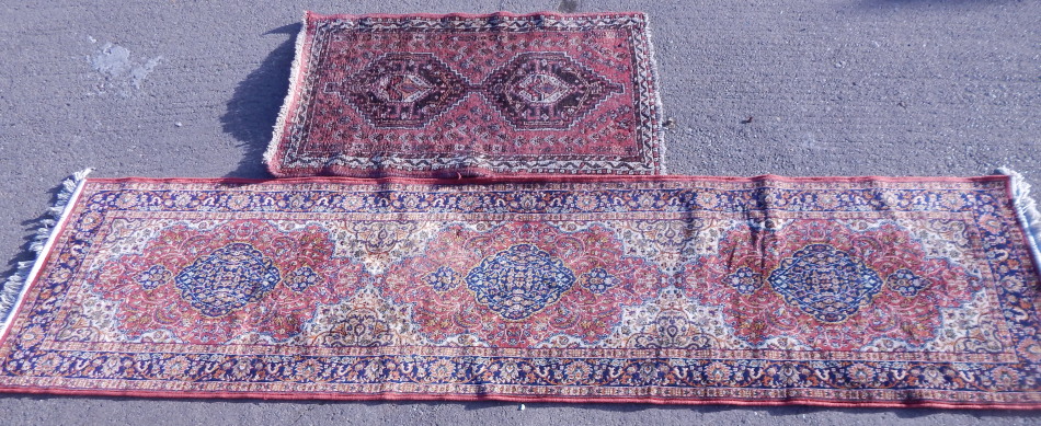 Appraisal: A Persian style rug in geometric pattern predominately in red