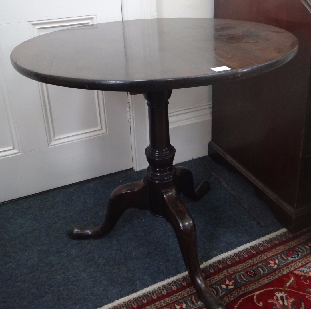 Appraisal: A George III mahogany tea table the circular tilt-top on