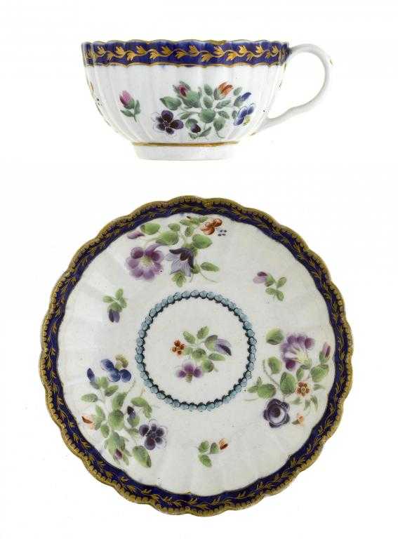 Appraisal: A WORCESTER REEDED TEACUP AND SAUCER enamelled with three loose