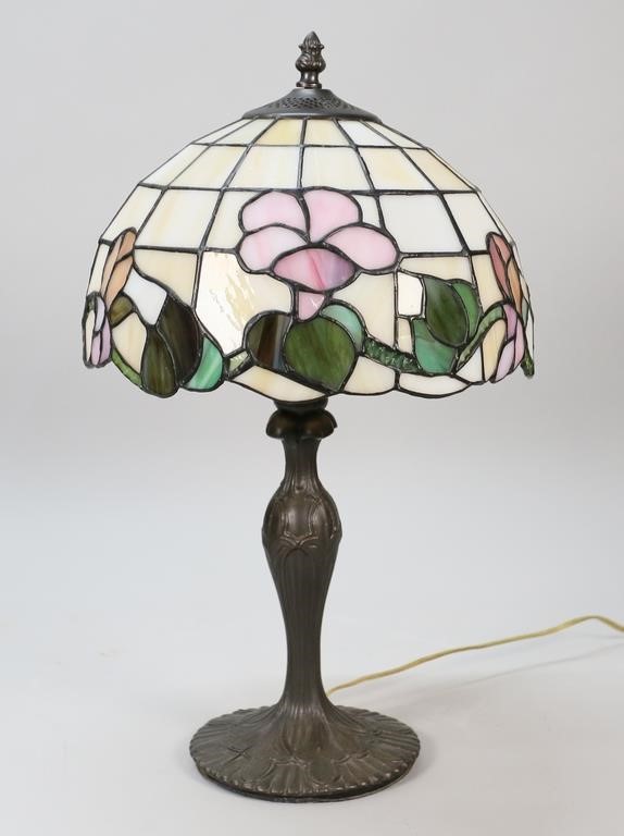 Appraisal: Patinated metal lamp with leaded glass shade Unsigned H shade