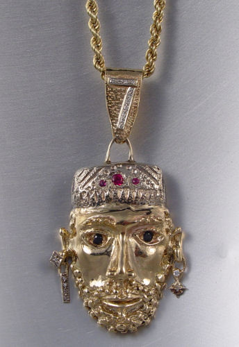 Appraisal: K FIGURAL PENDANT CHAIN K yellow gold pendant depicting a