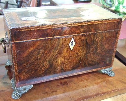 Appraisal: A Regency walnut and rosewood inlaid tea caddy the rectangular