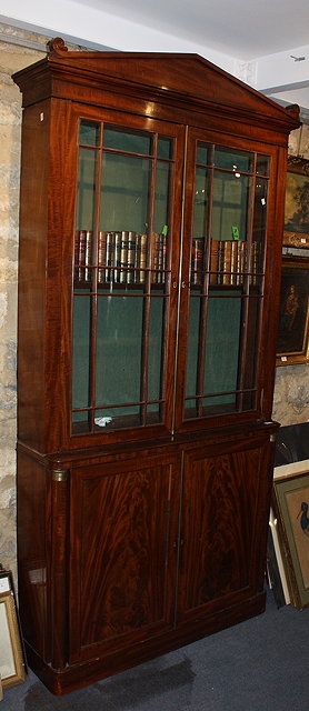 Appraisal: A MAHOGANY LIBRARY BOOKCASE CONSTRUCTED IN THREE SECTIONS with architectural