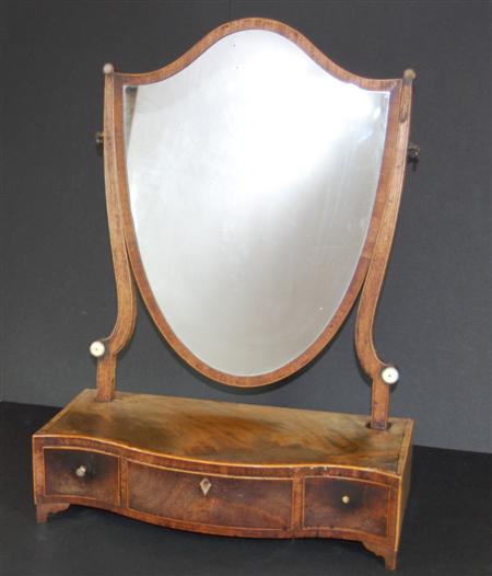 Appraisal: A th century mahogany serpentine dressing mirror with a shield