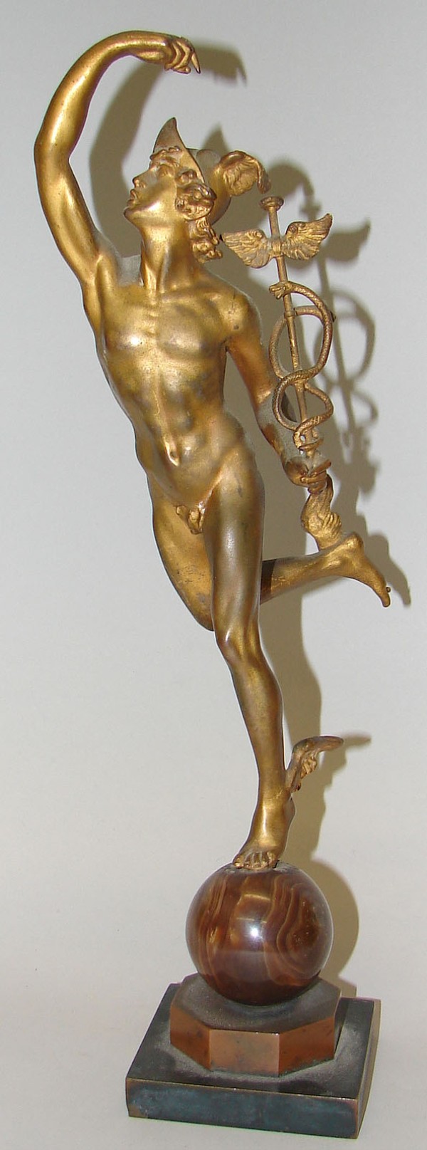 Appraisal: Figure of Hermes balancing on ball holding a caduceus figure