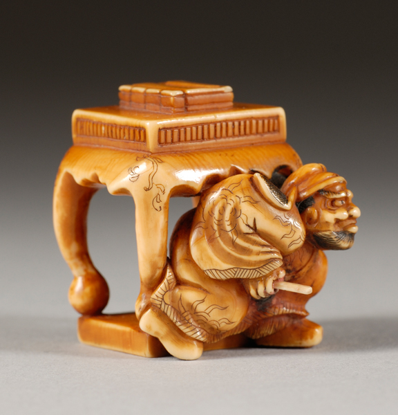 Appraisal: Ivory Netsuke th century Shoki beneath a table with a