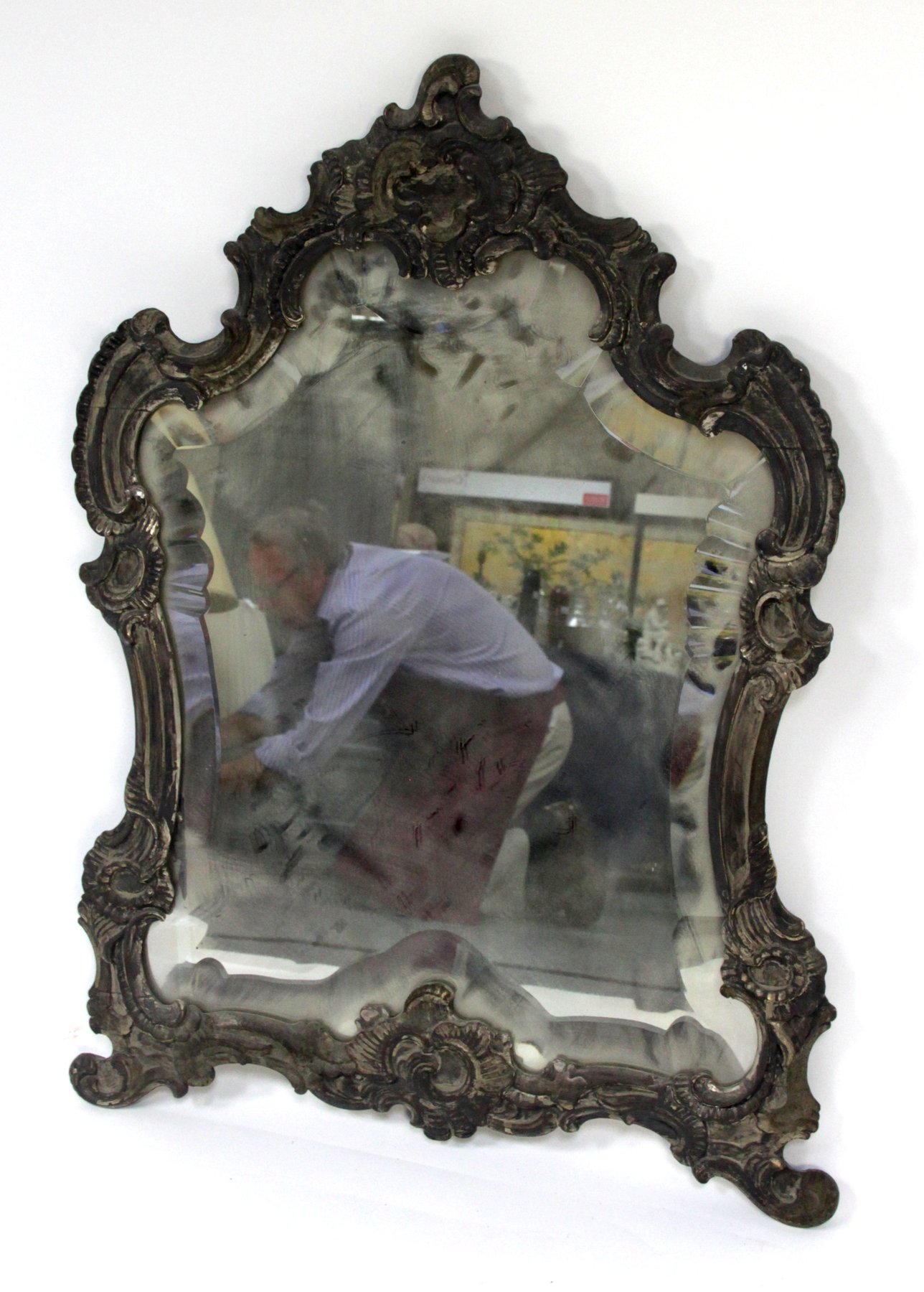 Appraisal: An easel mirror the carved scrolling frame to a bevelled