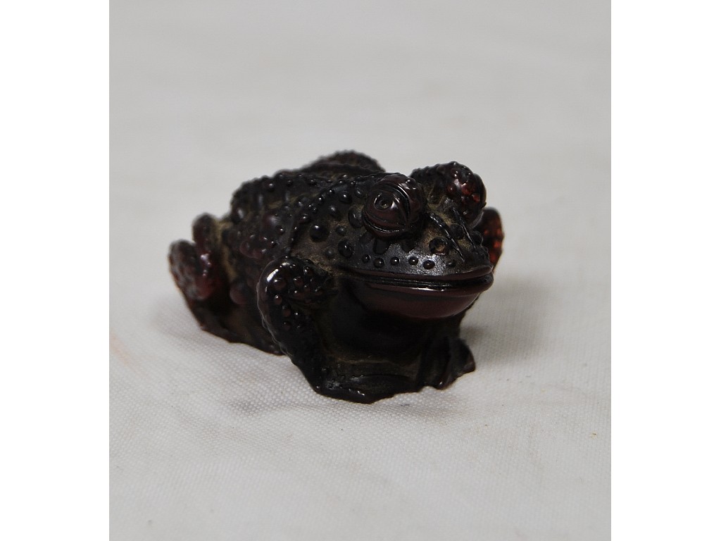 Appraisal: A Japanese simulated amber netsuke modelled as a toad