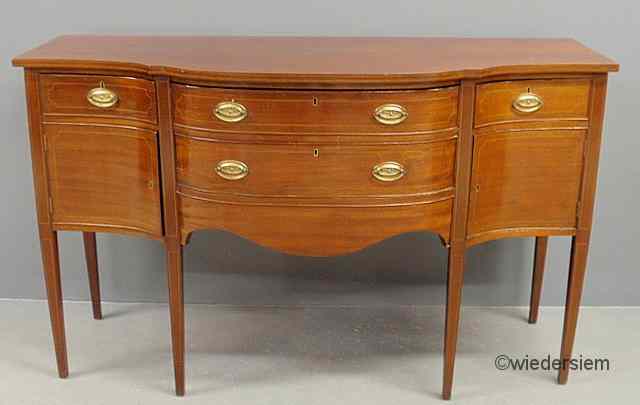 Appraisal: Hepplewhite style inlaid mahogany sideboard with a shaped top and