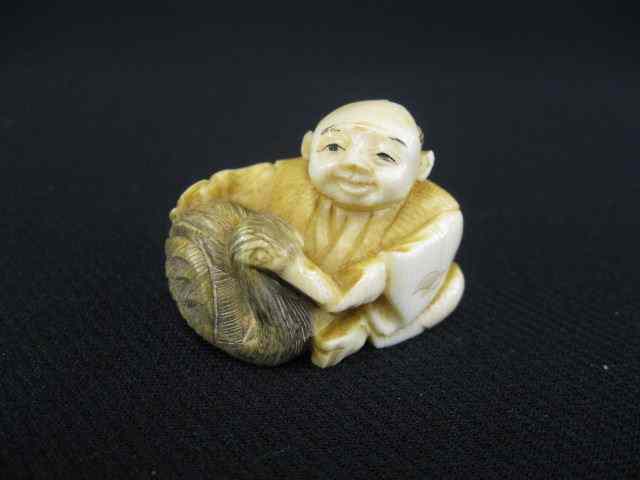 Appraisal: Carved Ivory Netsuke of a Seated Man with a fishing