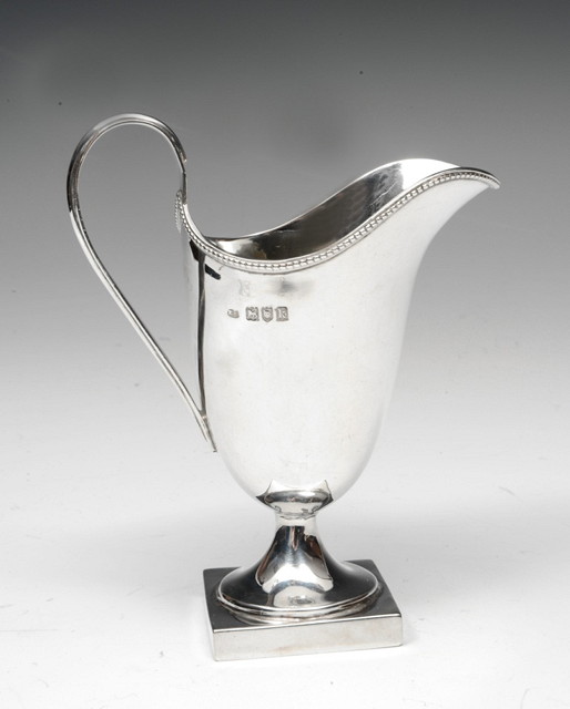 Appraisal: A GEORGIAN STYLE SILVER HELMET SHAPED CREAM JUG with beaded