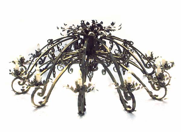 Appraisal: A Spanish Baroque style wrought and patinated metal twelve light