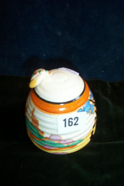 Appraisal: A Clarice Cliff Bizarre honey pot and cover modelled as