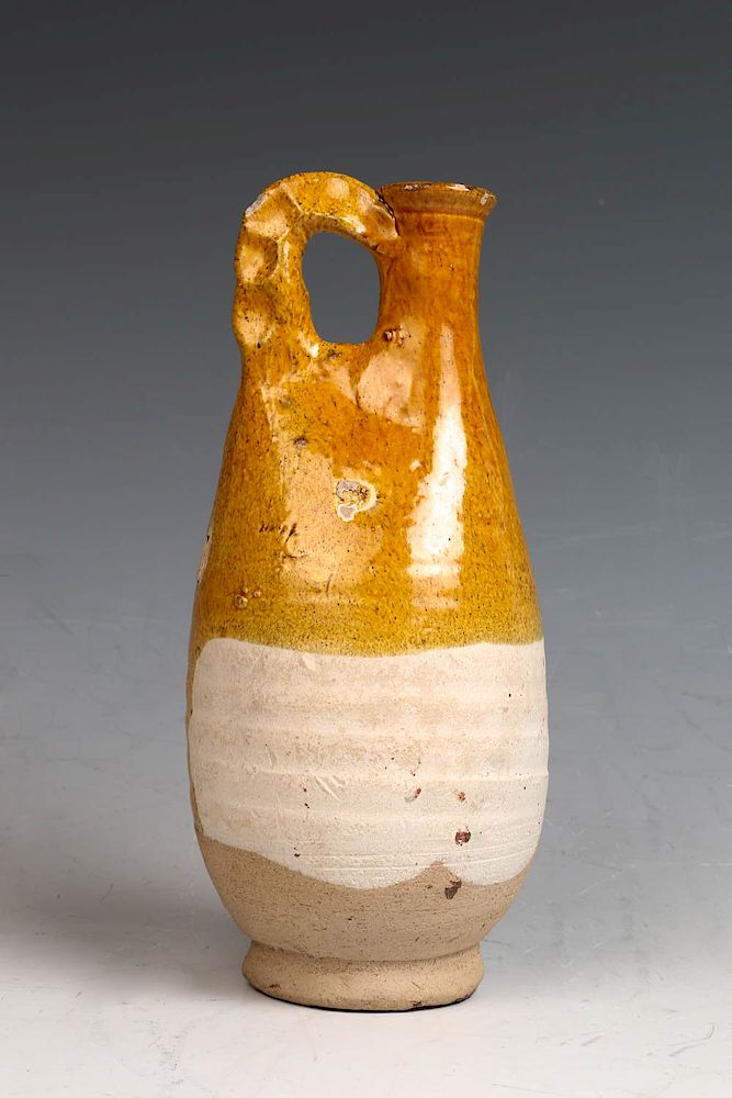 Appraisal: CHINESE YELLOW STRAW GLAZE EWER TANG DYNASTY The base of