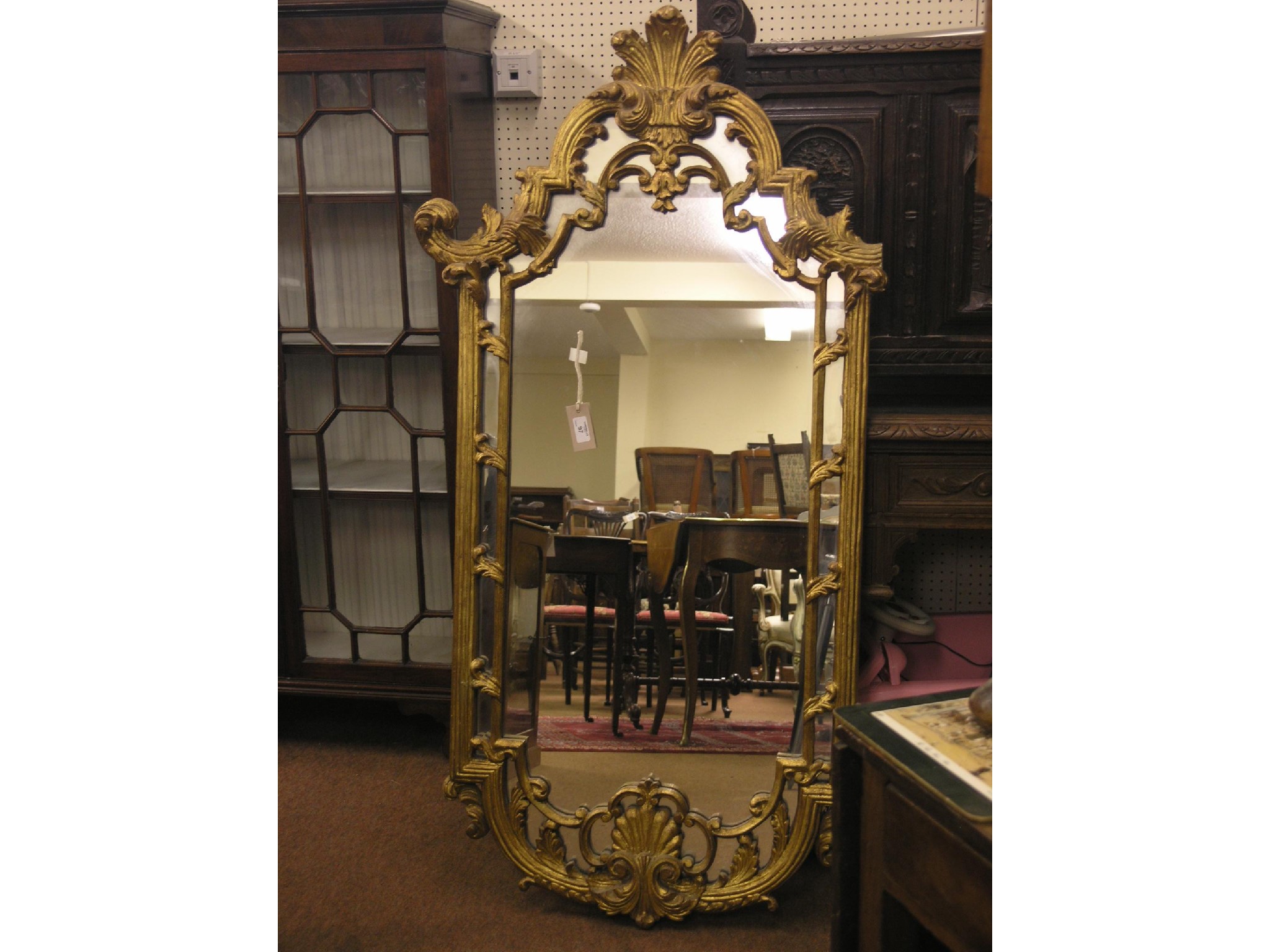 Appraisal: A large rococo-style gilt-framed mirror arched-shape with plume cresting and