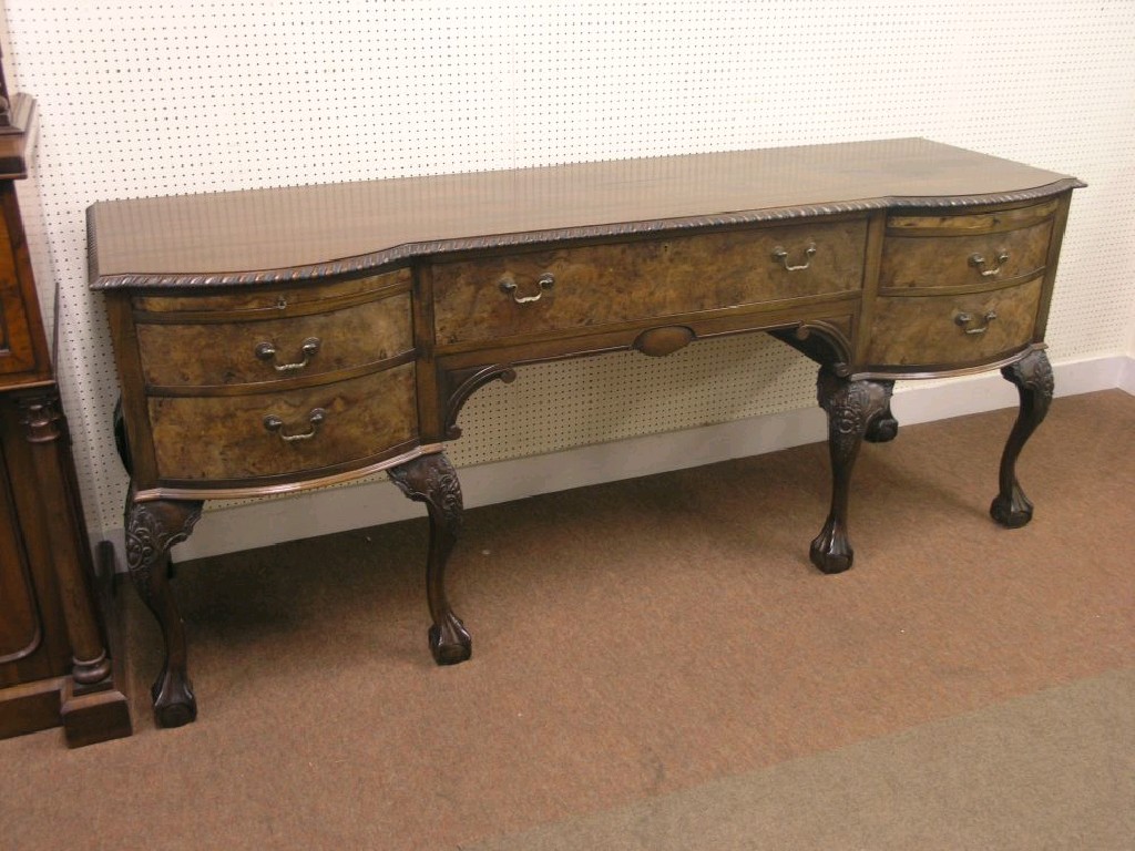 Appraisal: A large early th century burr walnut veneered sideboard gadrooned