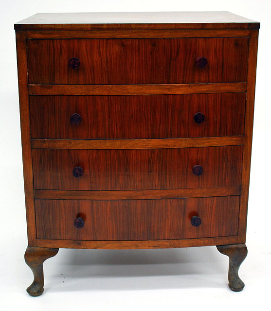 Appraisal: A SMALL WALNUT BOW FRONTED CHEST OF FOUR LONG DRAWERS