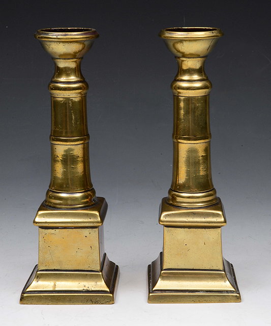 Appraisal: A PAIR OF TH CENTURY BRASS GUN BARREL CANDLESTICKS on