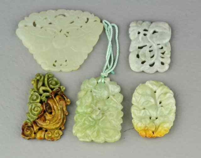 Appraisal: Chinese Carved Jade Jadeite PendantsDepicting butterflies and various fruit and