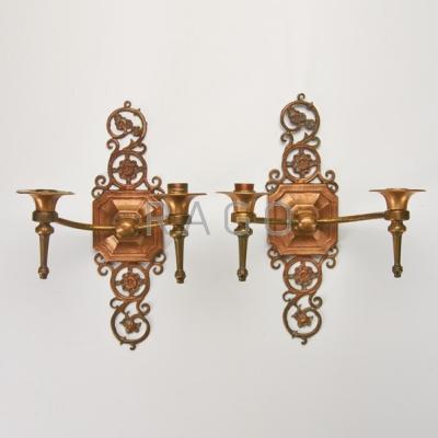 Appraisal: OSCAR BACH Pair of hammered bronze two-light candle sconces Marked