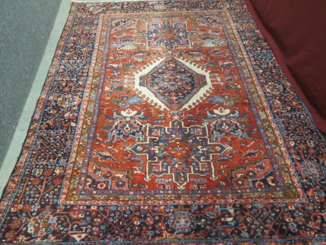 Appraisal: Heriz Persian Handmade Rug primarly reds blue and ivory '