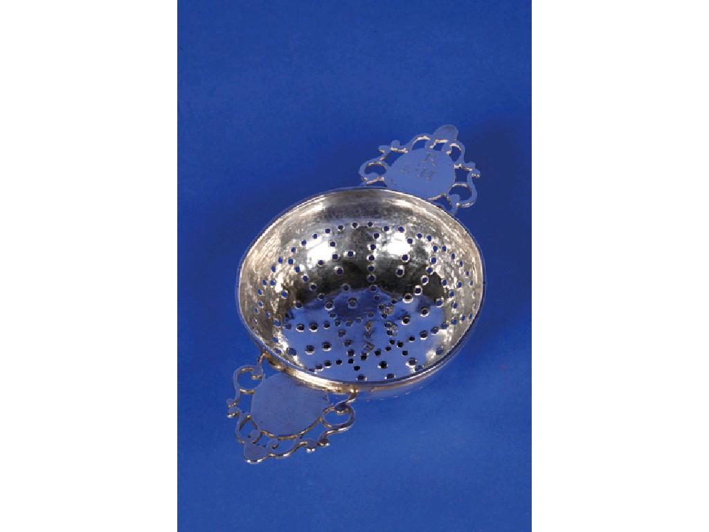 Appraisal: A BRITANNIA STANDARD LEMON STRAINER with pierced lug handles bearing