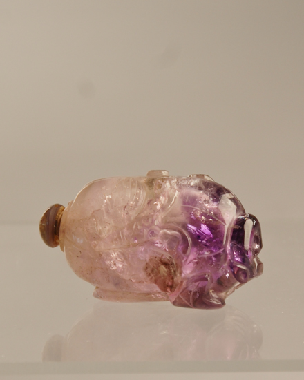 Appraisal: A th C Carved Amethyst Pebble Snuff Bottle with relief