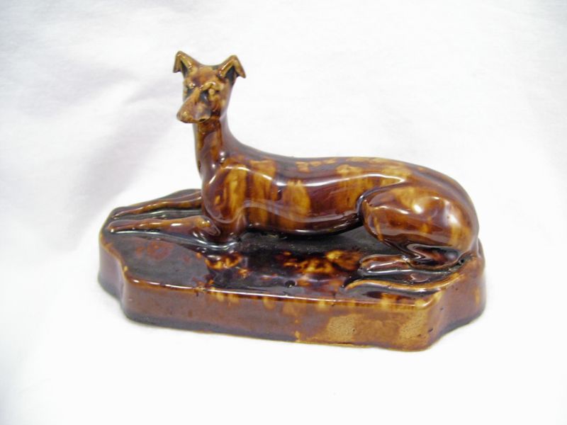 Appraisal: Rockingham Pottery Figural Paperweight Brown mottled glaze over a stoneware