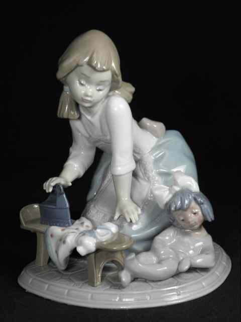 Appraisal: Lladro Spanish porcelain figurine titled ''Girl Ironing'' Marked on base