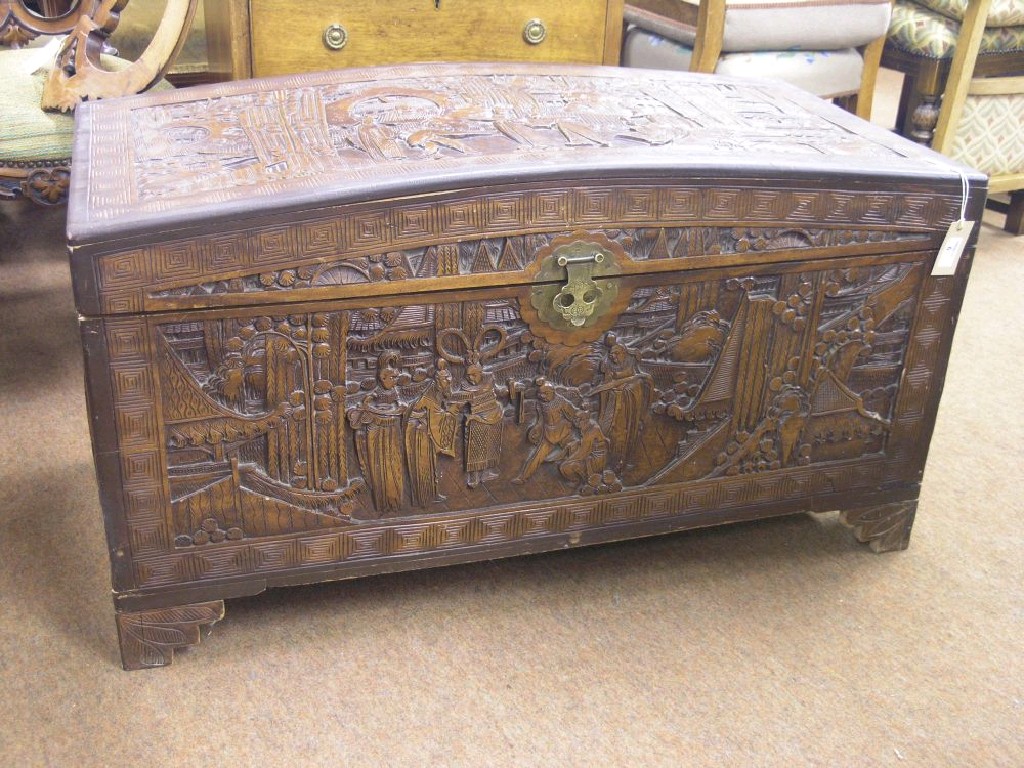 Appraisal: A Chinese camphorwood trunk carved with figures at various pursuits