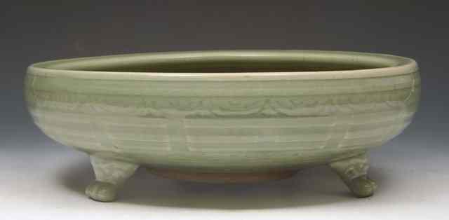 Appraisal: A CHINESE CELADON CIRCULAR LARGE BOWL with relief moulded border