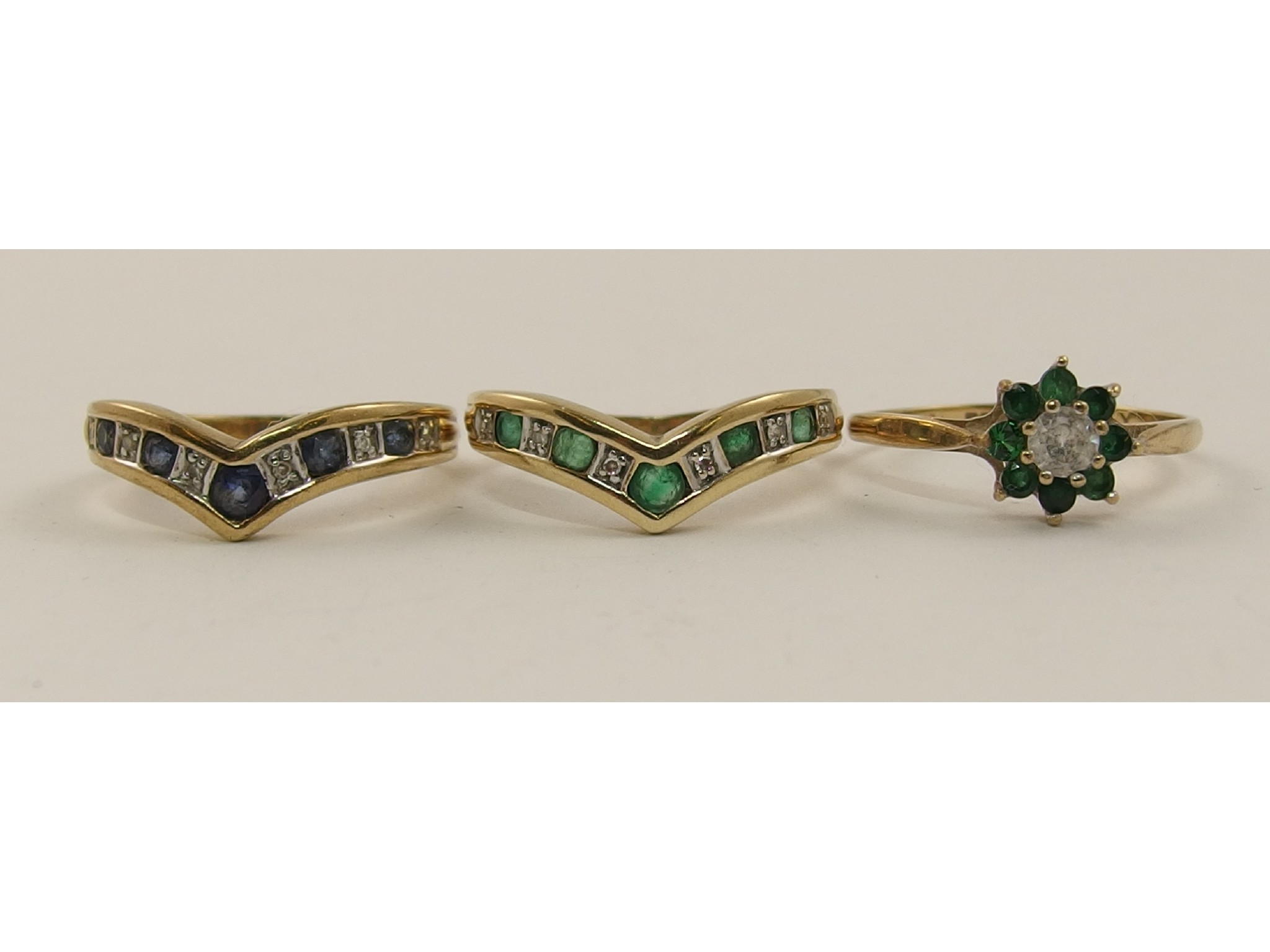 Appraisal: Two 'V' shaped rings set with diamonds sapphires and emeralds