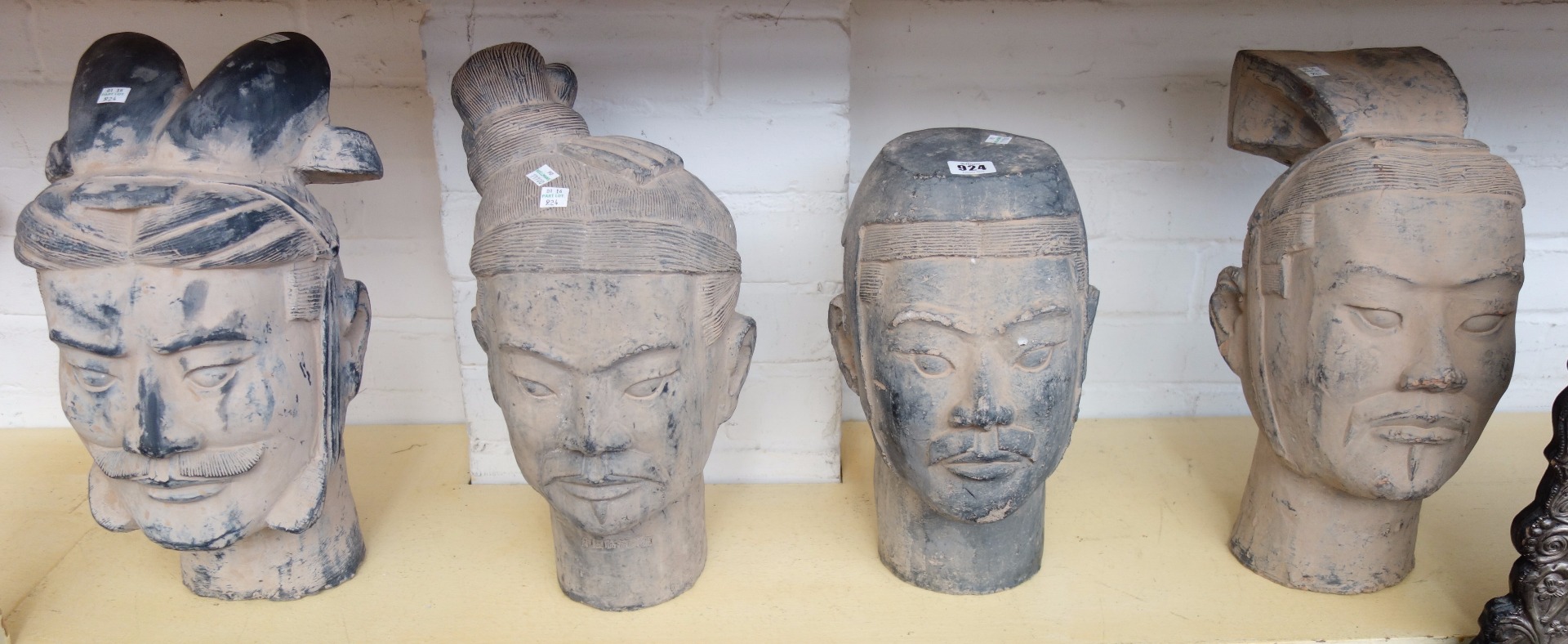 Appraisal: A set of four modern pottery terracotta army figure heads