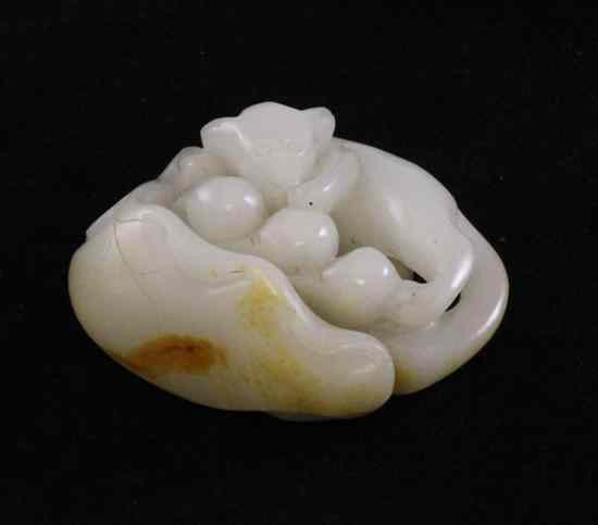 Appraisal: A Chinese white and russet jade carving in the form