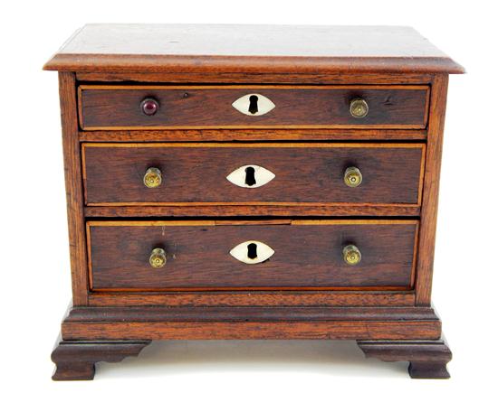 Appraisal: th C American Chippendale form miniature chest mahogany chest with