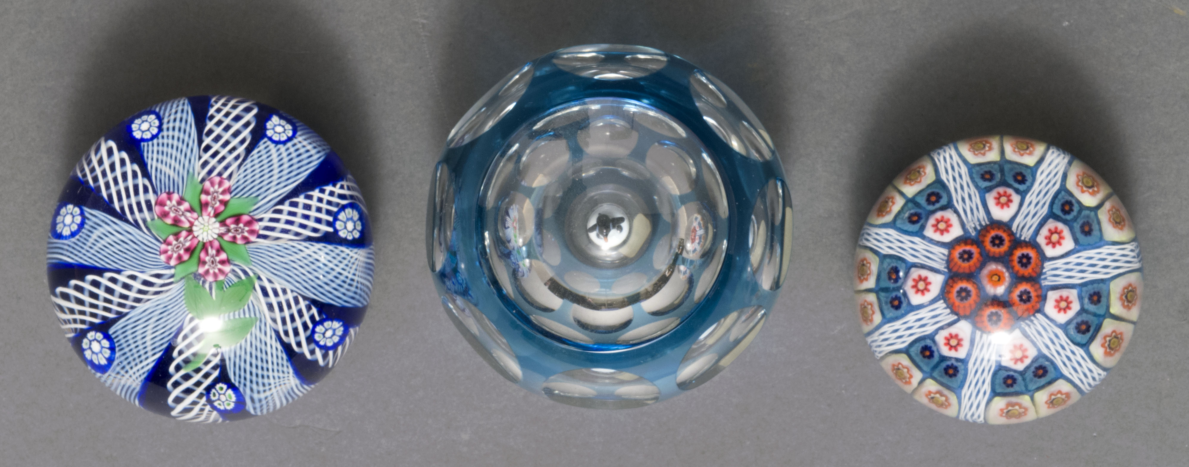 Appraisal: THREE GLASS PAPERWEIGHTS th CenturyPerthshire faceted cut overlay blue-to-clear with