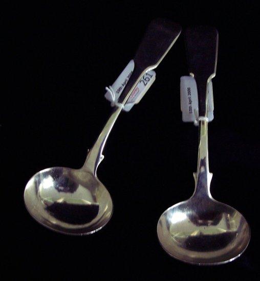 Appraisal: A pair of William IV sauce ladles of fiddle pattern