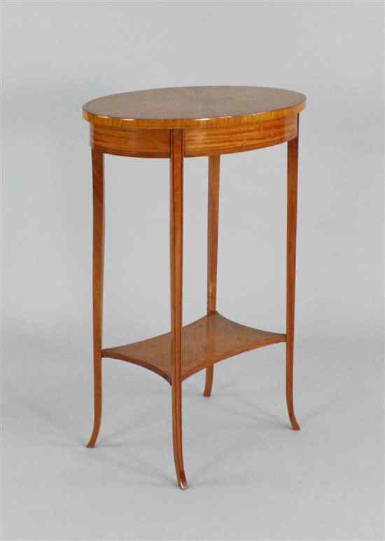 Appraisal: An Edwardian satinwood two tier occasional table ft ins x