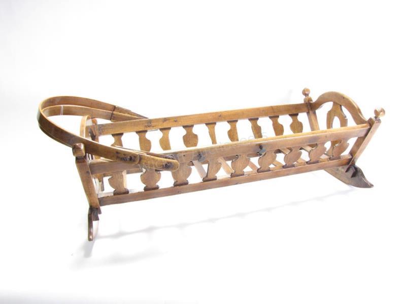 Appraisal: An antique baby cradle with wooden bail handles rockers refinished