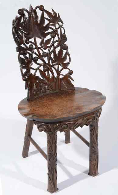 Appraisal: A NORTH INDIAN HARDWOOD CHAIR with open carved leaf back