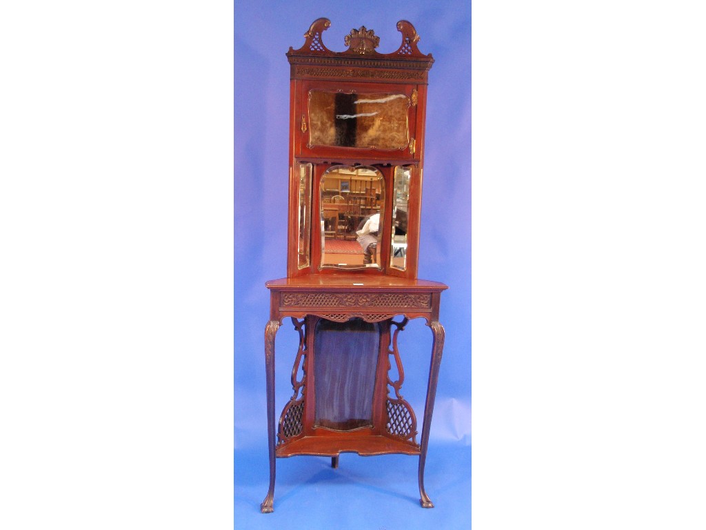 Appraisal: A late Victorian mahogany corner cabinet with blind and open