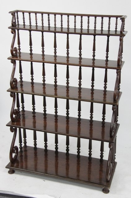 Appraisal: A mahogany set of five open shelves with scroll supports