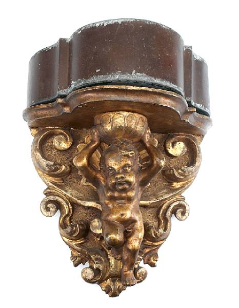 Appraisal: A pair of Italian giltwood wall brackets supported by putti